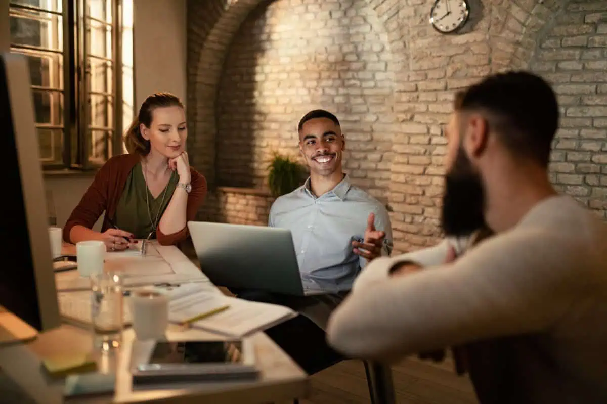 Equipo de una startup colaborando en una reunión en un entorno de oficina.